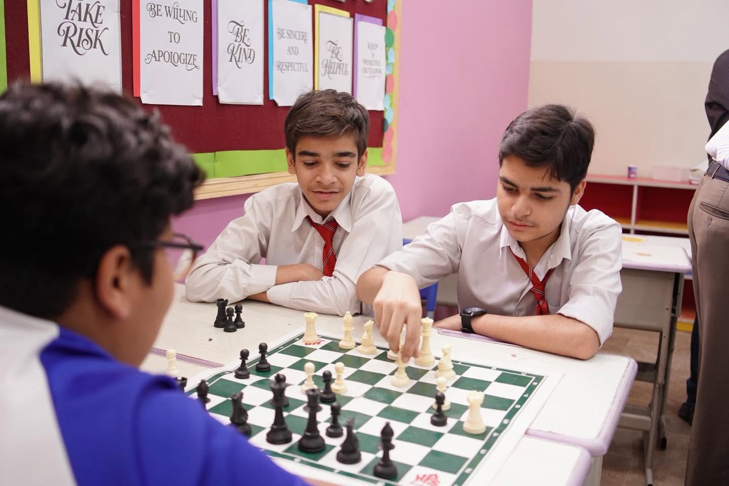 Students concentrating on their next chess move
