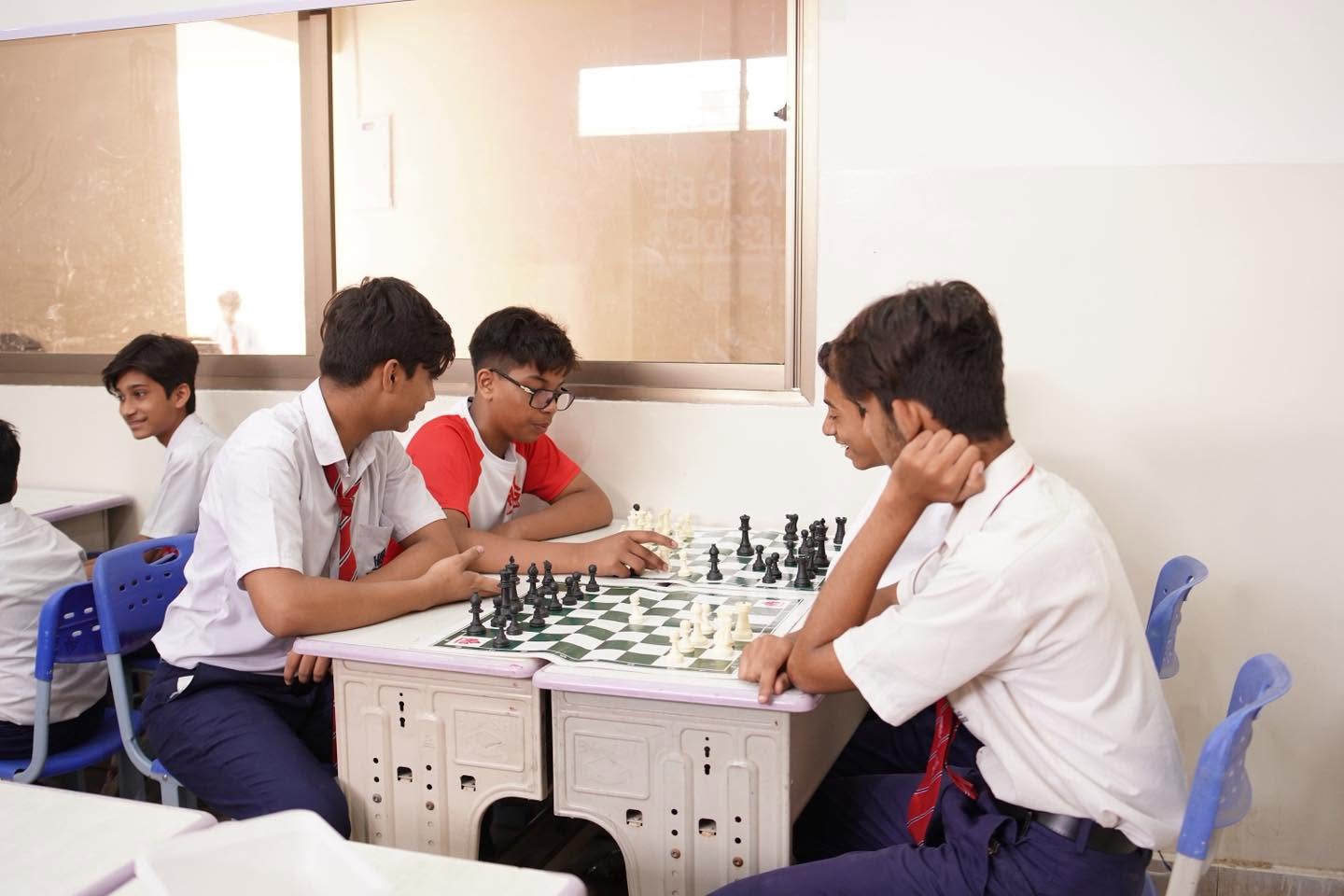 HPGS students discussing chess strategies in the classroom