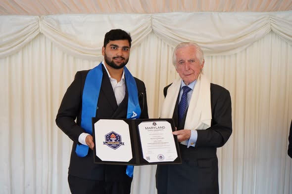 Mr Muhammad Faizan Khan receiving his honorary doctorate certificate at the London ceremony