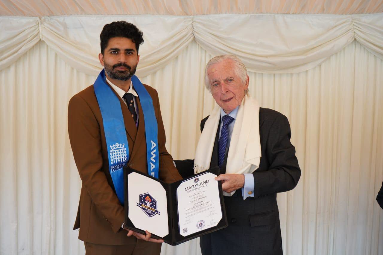 Mr Muhammad Hassan Khan receiving his honorary doctorate certificate at the London ceremony