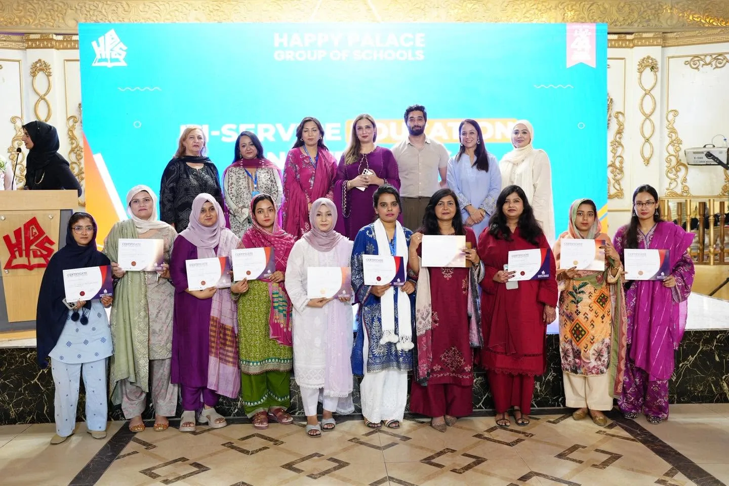 Educators holding certificates at the close of a learning session