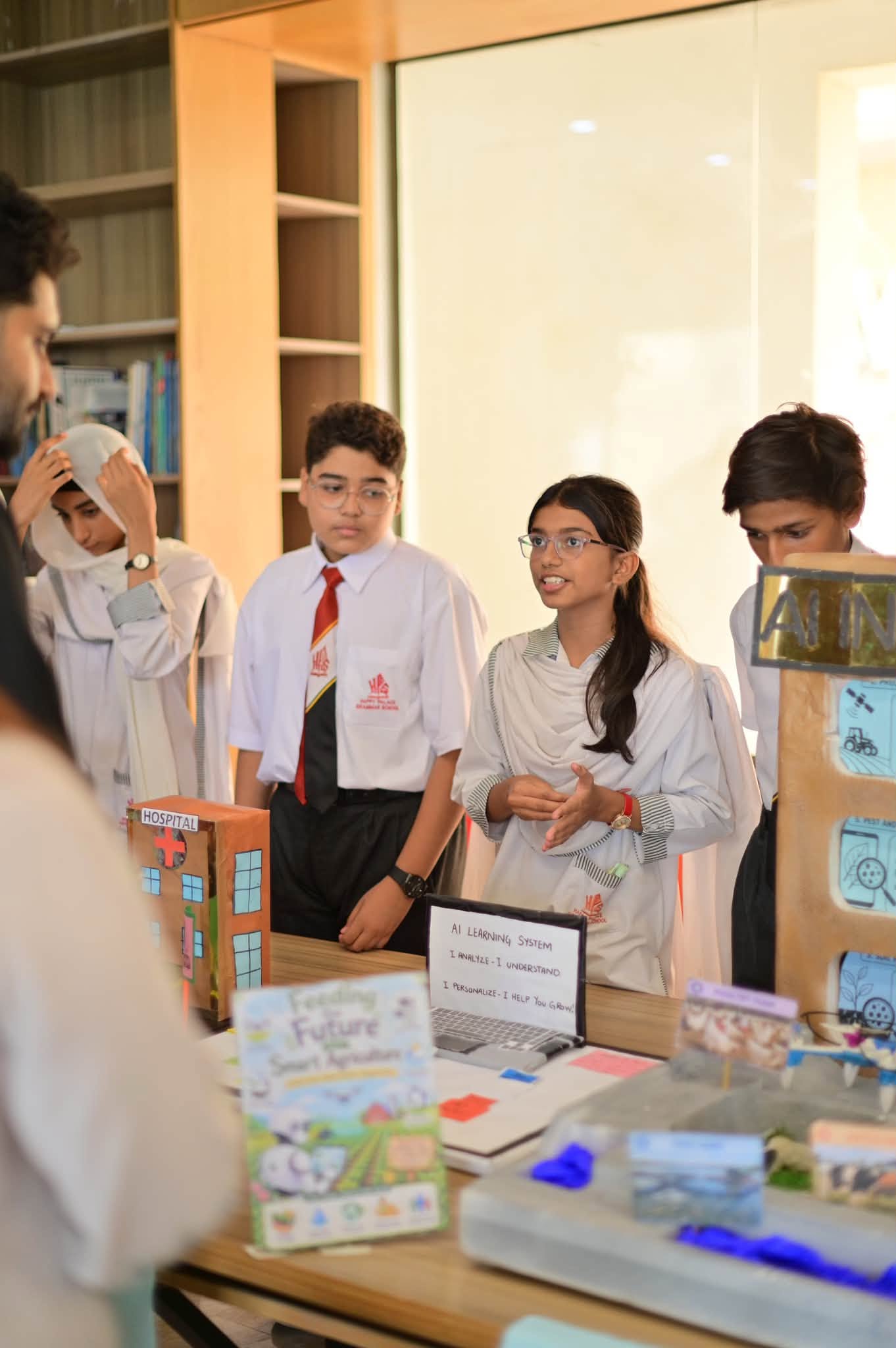 HPGS students presenting an artificial intelligence learning exhibit
