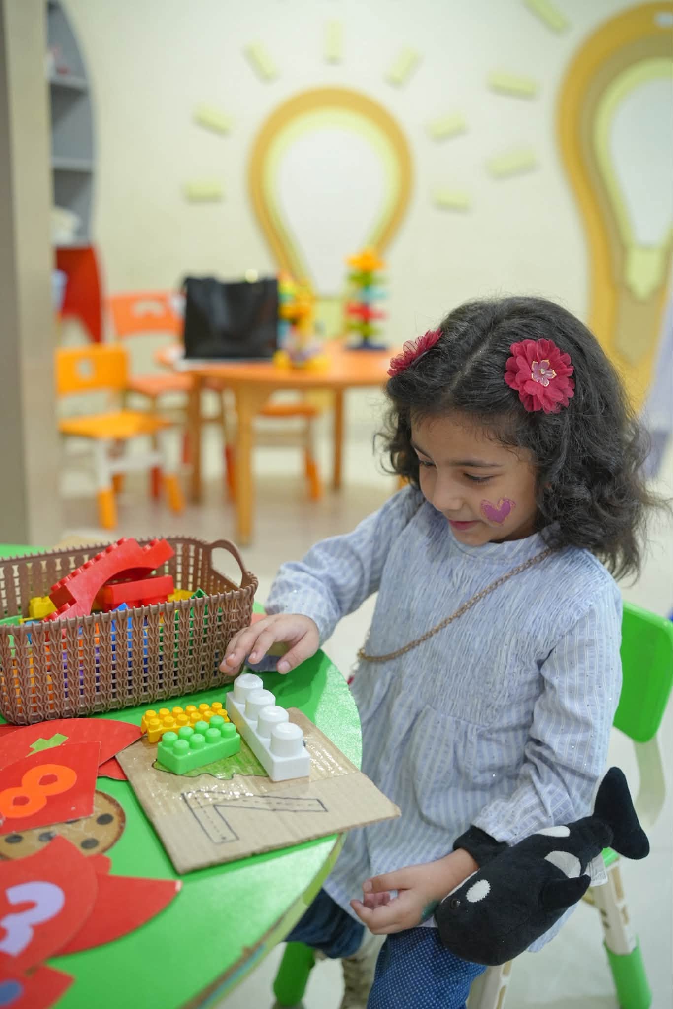 A young learner exploring a playful classroom activity at HPGS