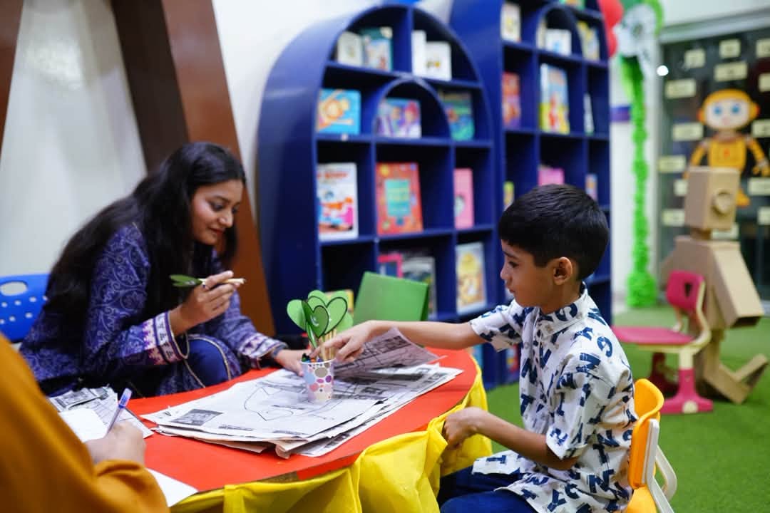 A child taking part in a hands-on learning activity during an HPGS Open House