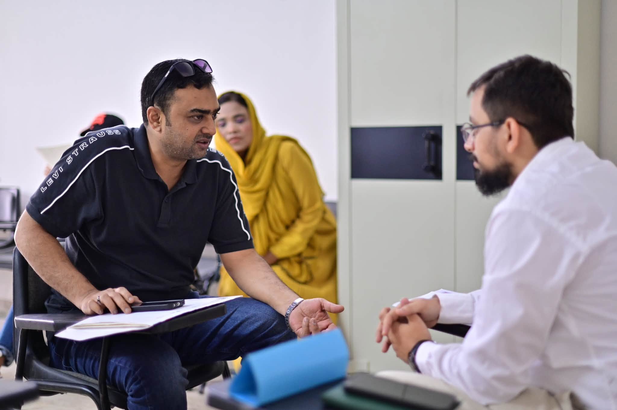 A parent and teacher discussing an academic pathway during an HPGS orientation session