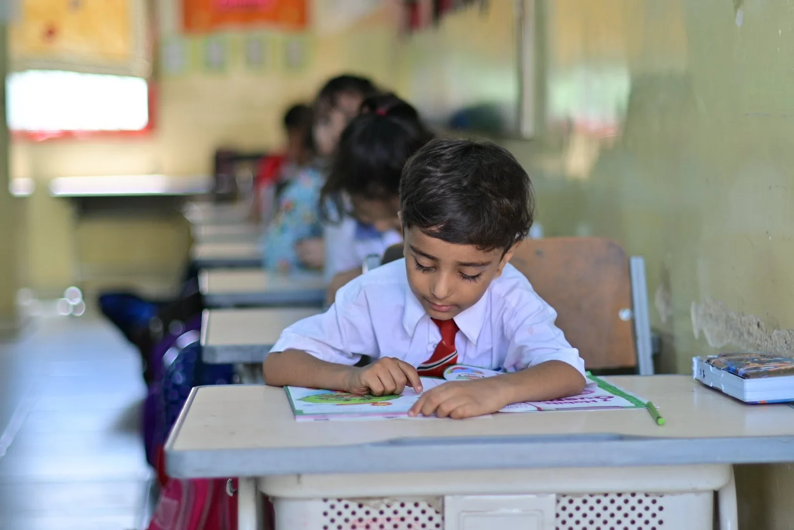 Primary Years student working carefully through a lesson workbook