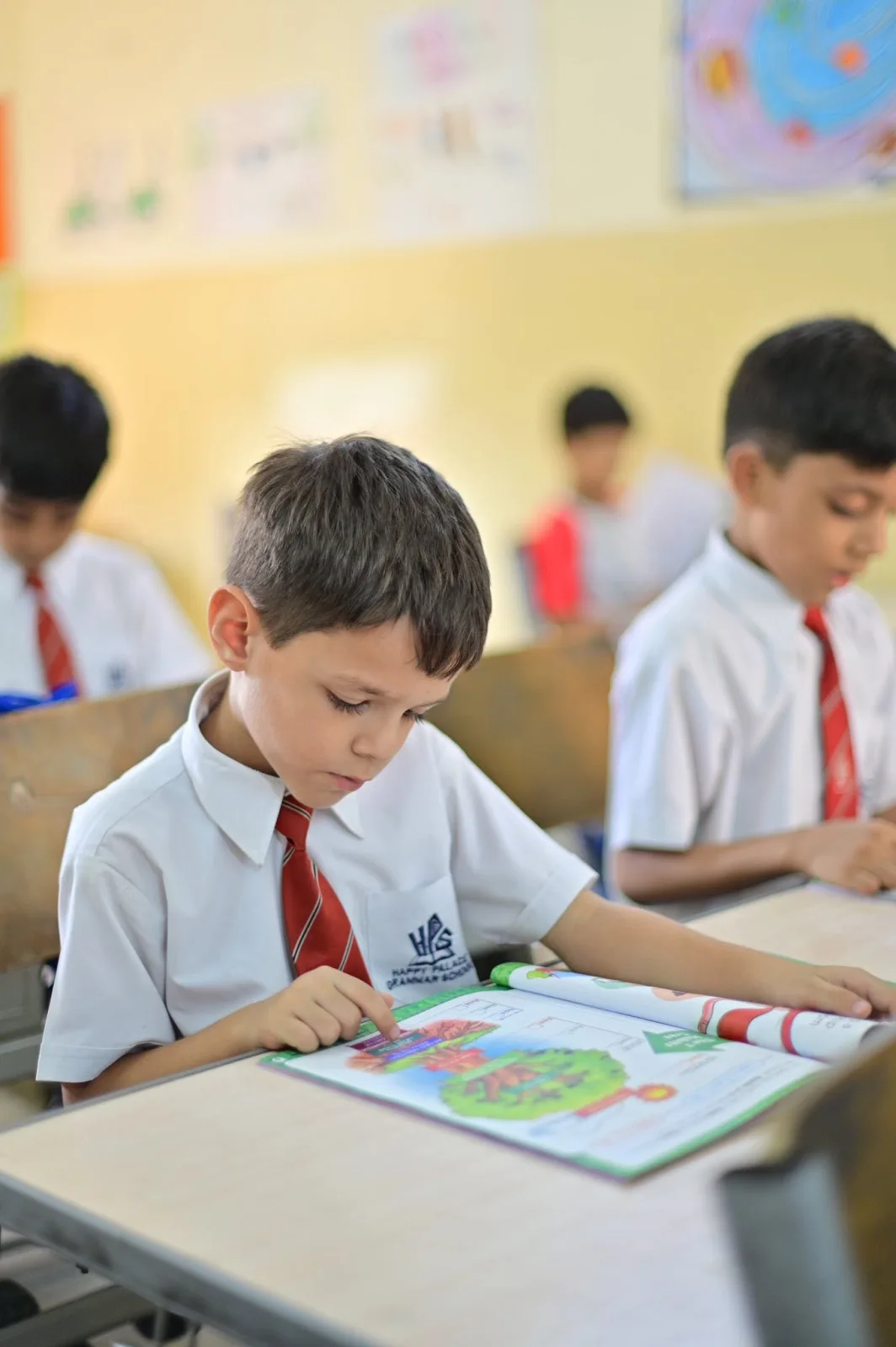 Primary Years student reading a LIM workbook during class