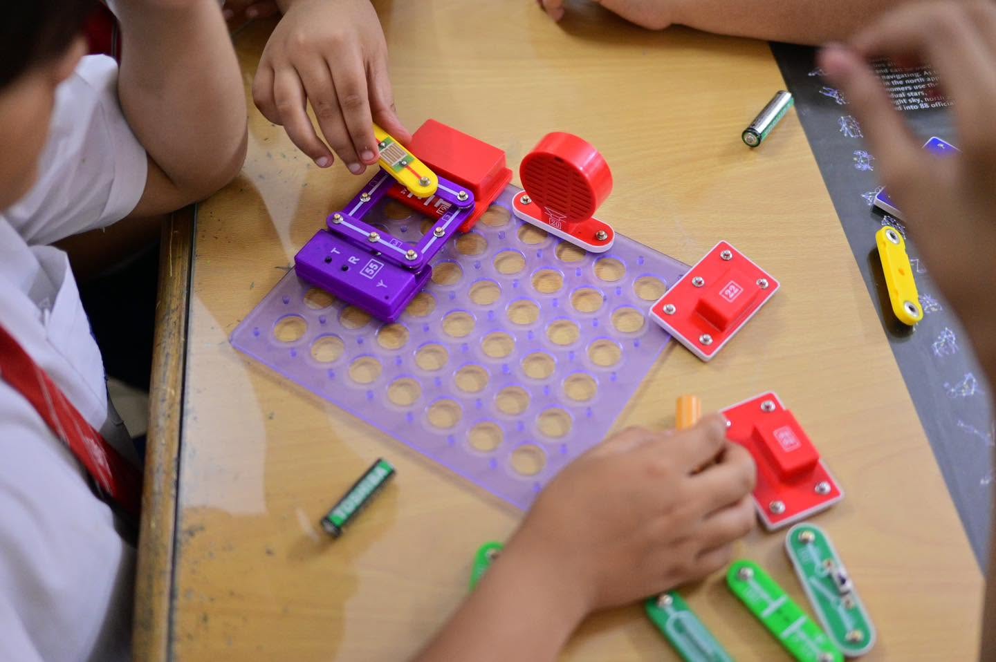 Students testing a colourful hands-on circuitry project